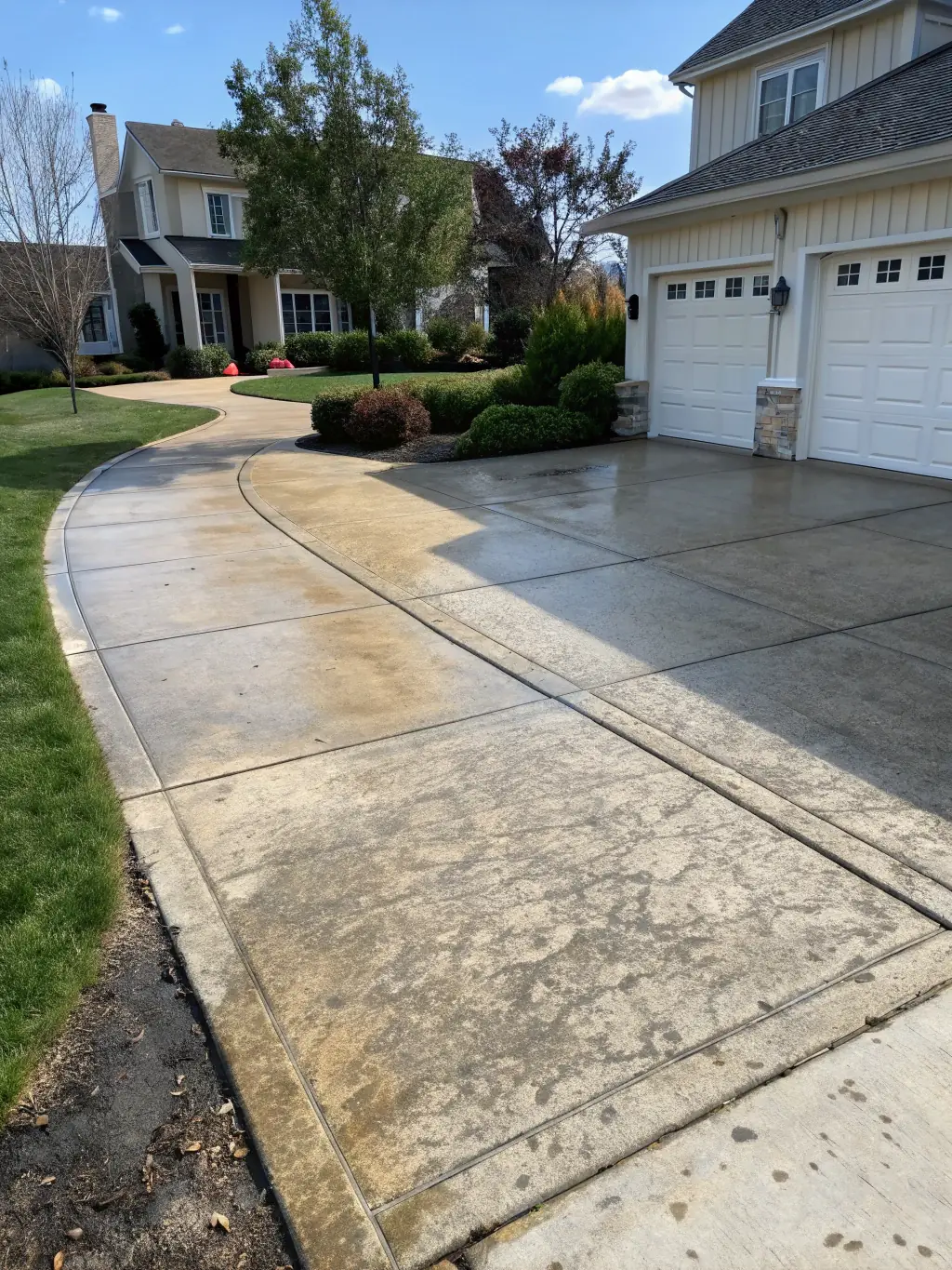 A before-and-after shot of a driveway cleaned and restored to a pristine condition.